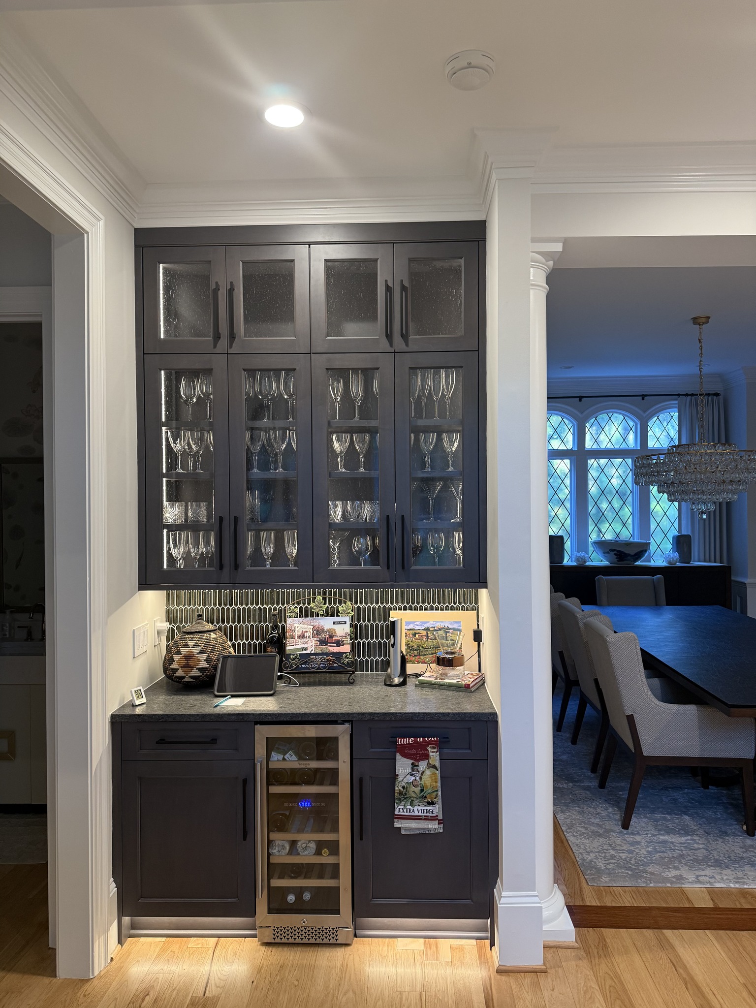 Dark kitchen with lit glass-front cabinets